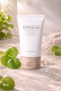 Tube of Madagascan Centella sunscreen with leaves on a light background
