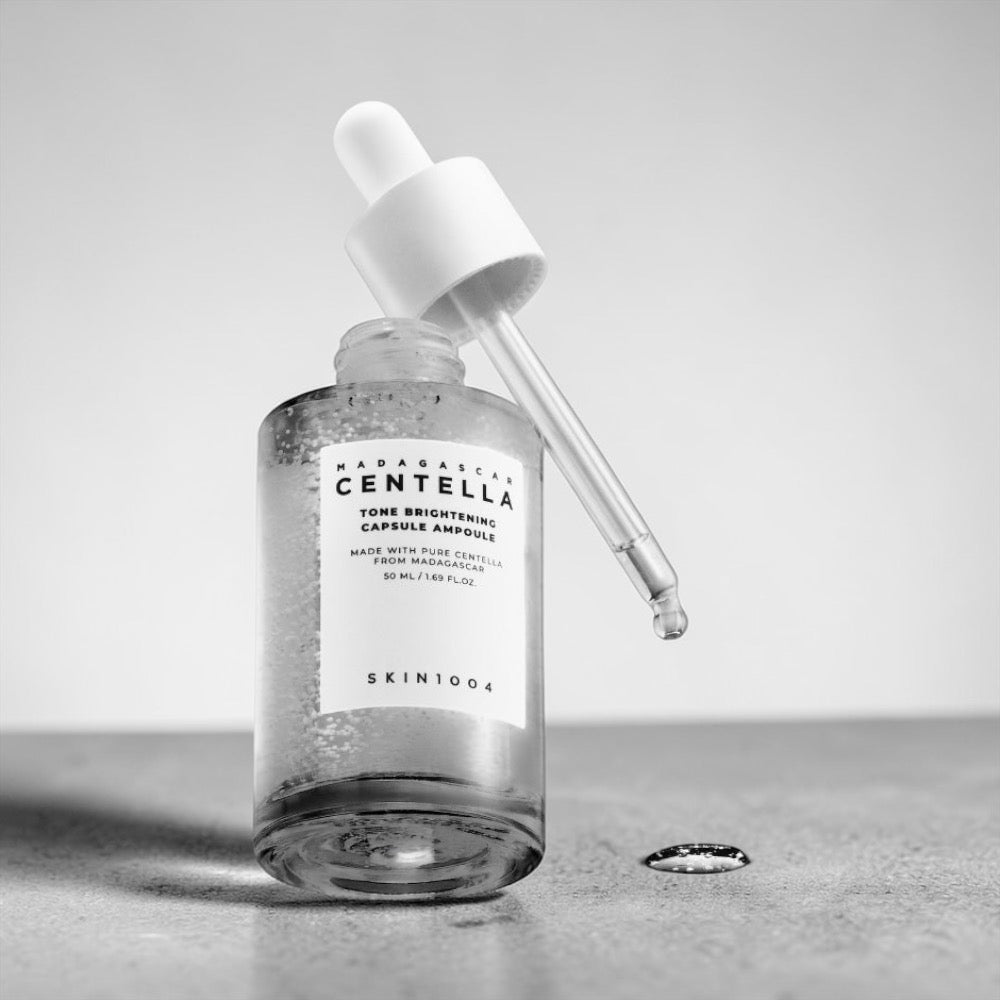 Skin 1004 Madagascar Centella  ampoule bottle with dropper on a gray surface