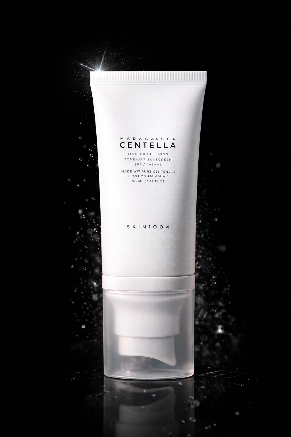Skin1004 Madagascar Centella Tone up Sunscreen in a white tube on a black background.