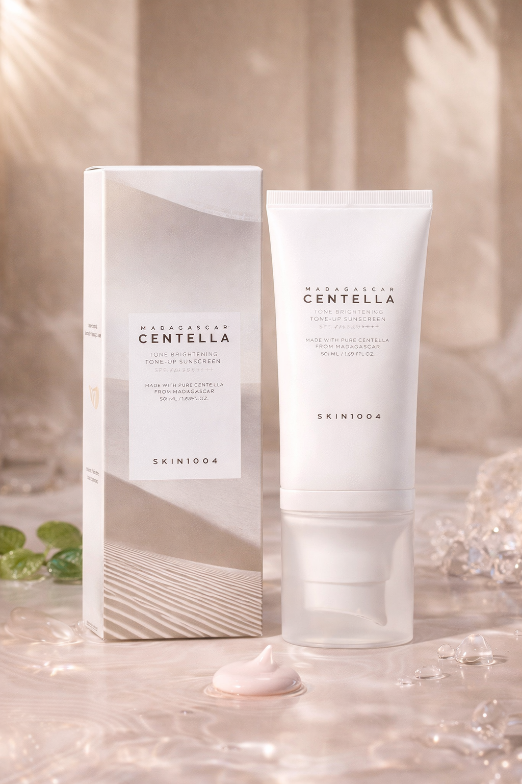 Skin1004 Madagascar Centella Tone Brightening Sunscreen in a white tube and packaging on beige background