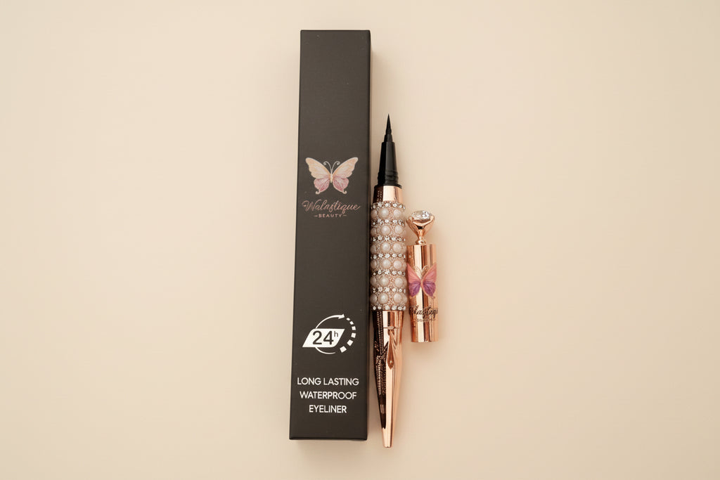 Walastique Beauty liquid eyeliner in rose gold and pearl design and black box packaging on a light background