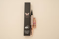 Walastique Beauty liquid eyeliner in rose gold and pearl design and black box packaging on a light background