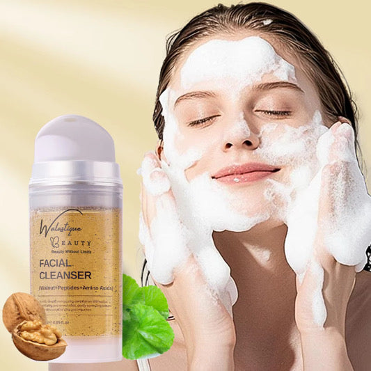 Woman applying facial cleanser with a bottle of Walastique Beauty Facial Cleanser on a beige background..