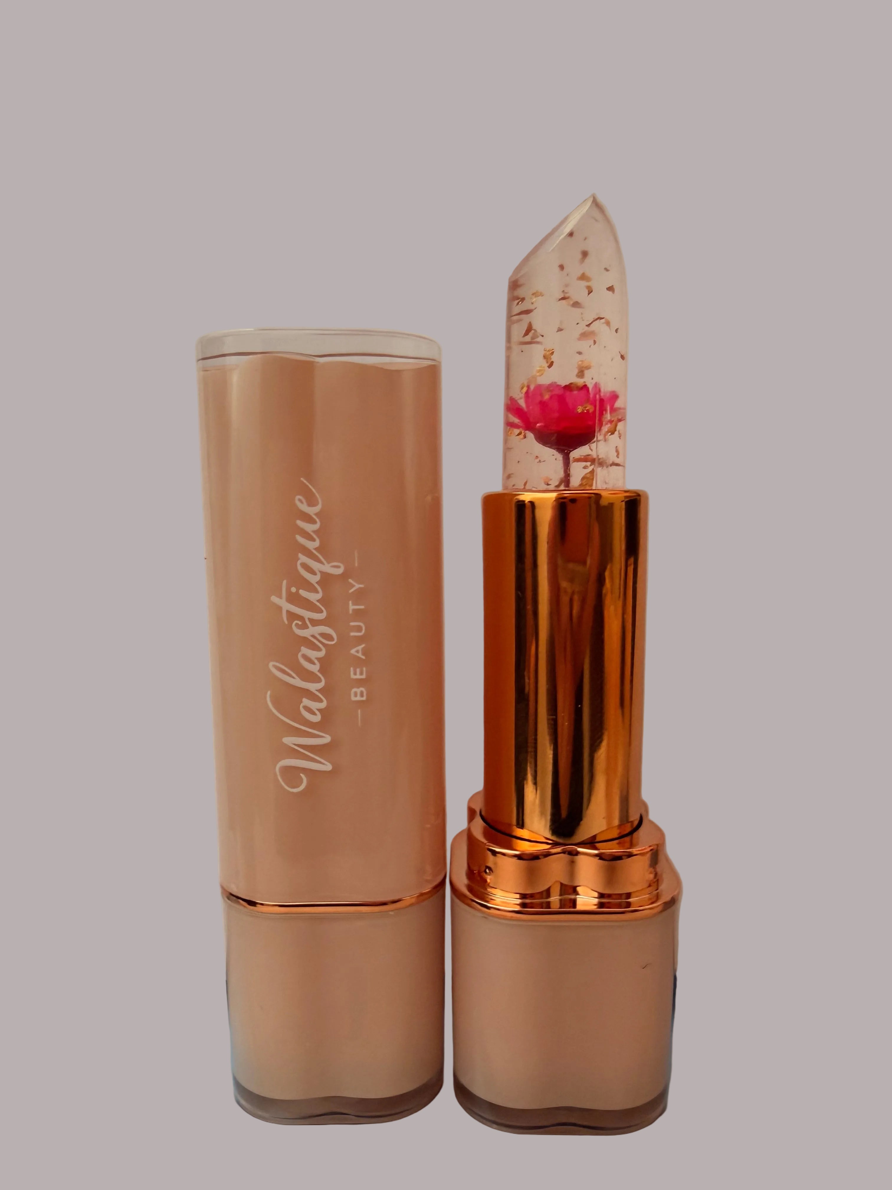 Lipstick with pink rose and rose gold casing and 'Walastique Beauty' branding on a neutral background