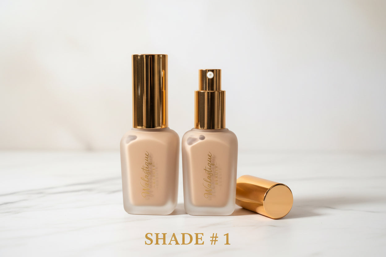 Two foundation bottles of Walastique Beauty  with gold caps on white background.