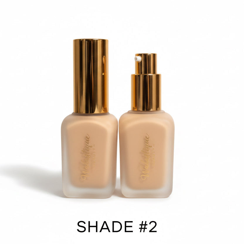 Two bottles of Walastique foundation with gold caps on a white background